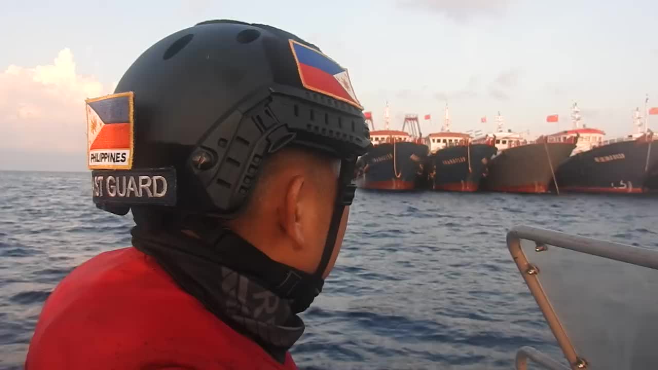 A Philippine Coast Guard RHIB, circles close and shows the flag to a ...
