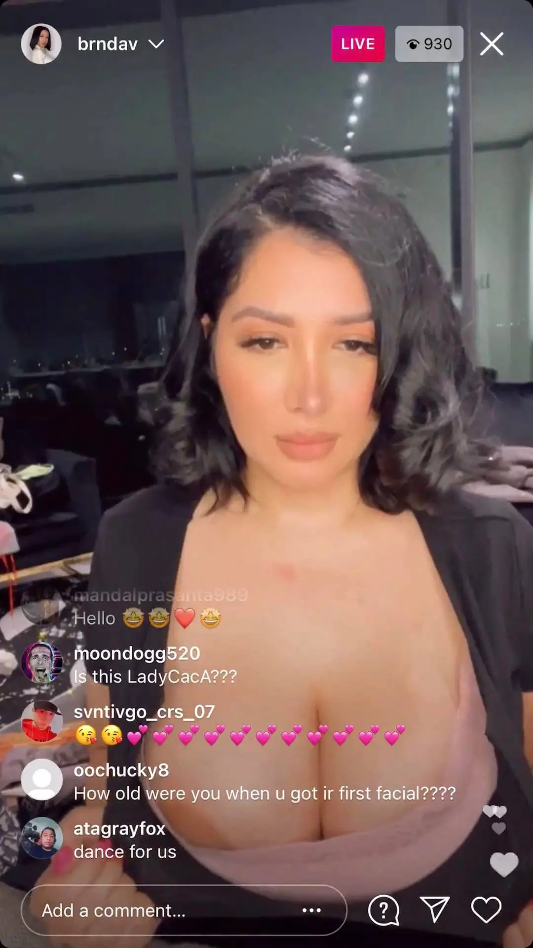 Brenda Vanessa livestreaming in a low-cut black top showing her busty latina figure and cleavage