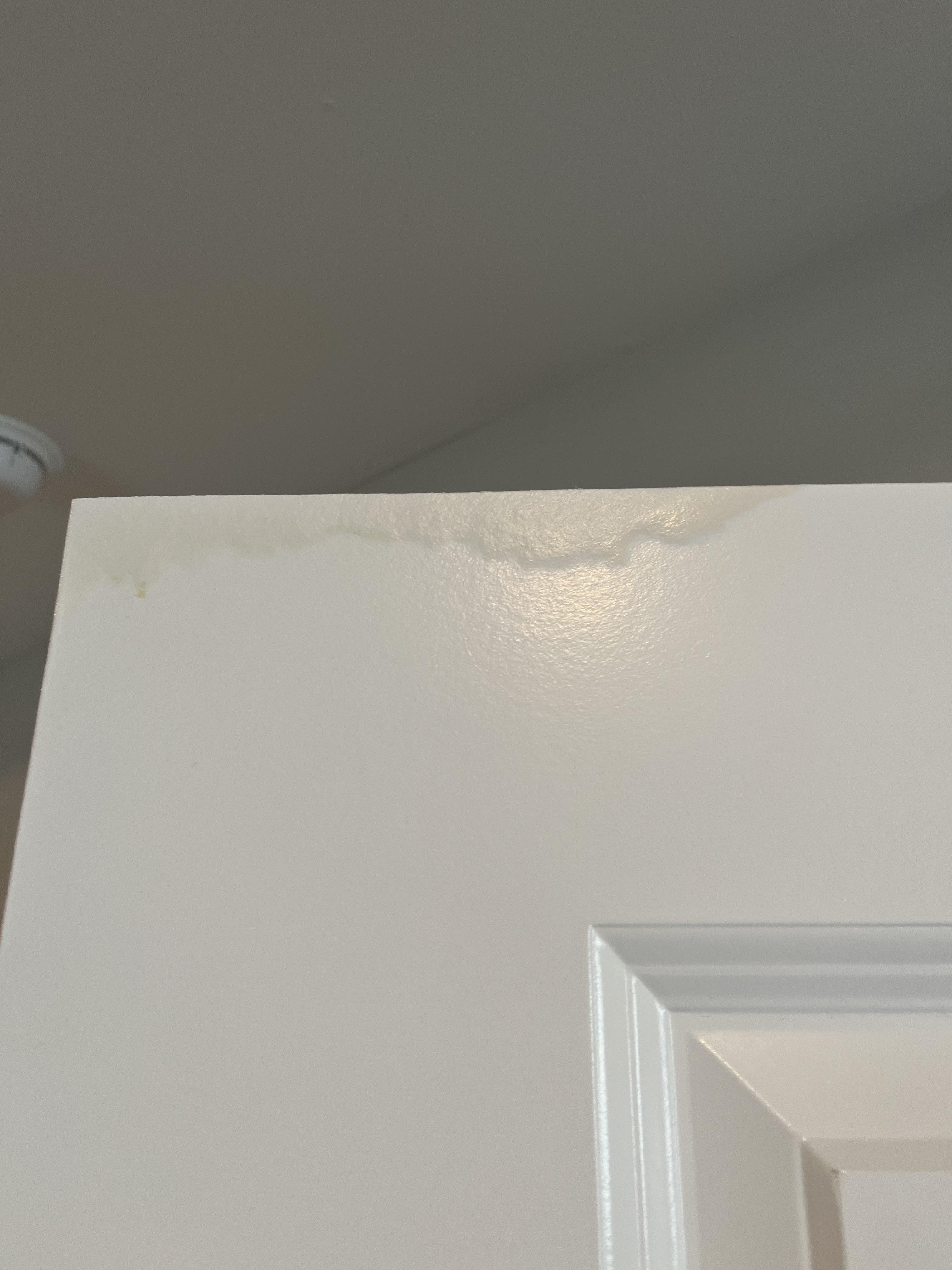 Left wet towel hanging on hollow core door. Easy fix or new door