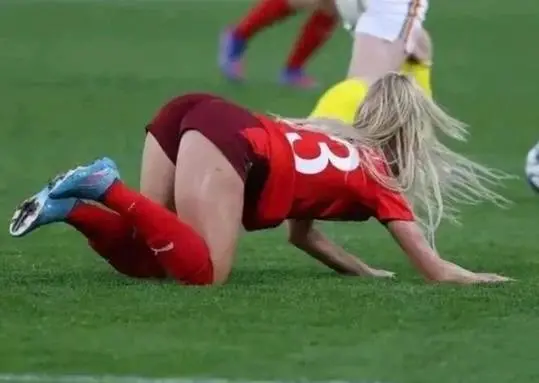 Alisha Lehmann in a red soccer uniform with number 3 on the grass field