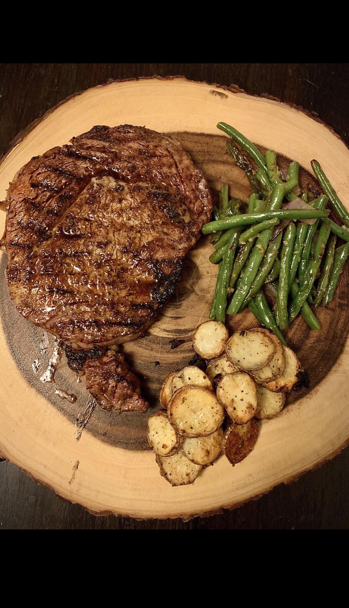 20 oz Ribeye cooked over hardwood lump with roasted veggies put on a ...