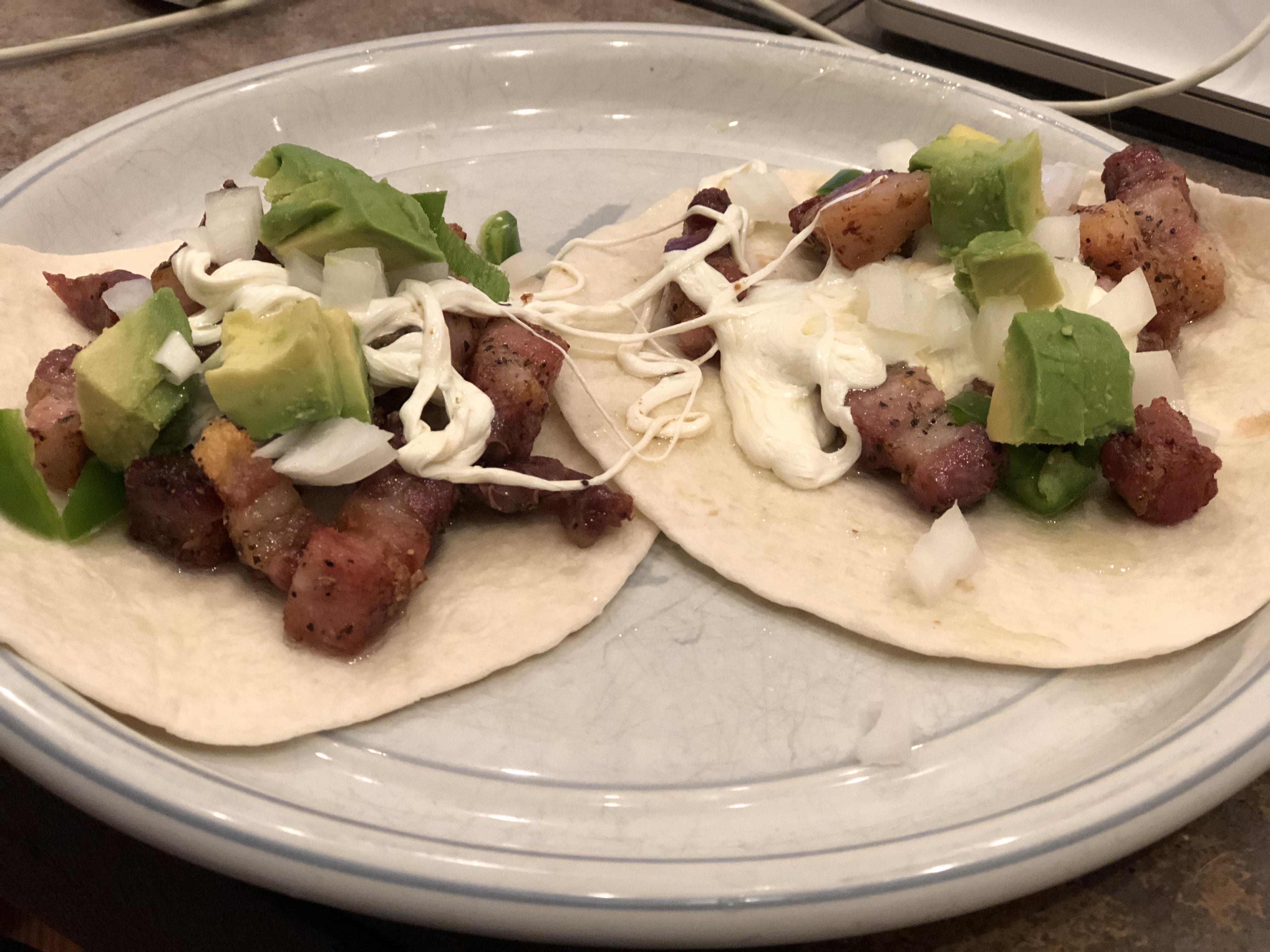 Crispy pork belly tacos with Oaxaca cheese, avocados, onions, and ...