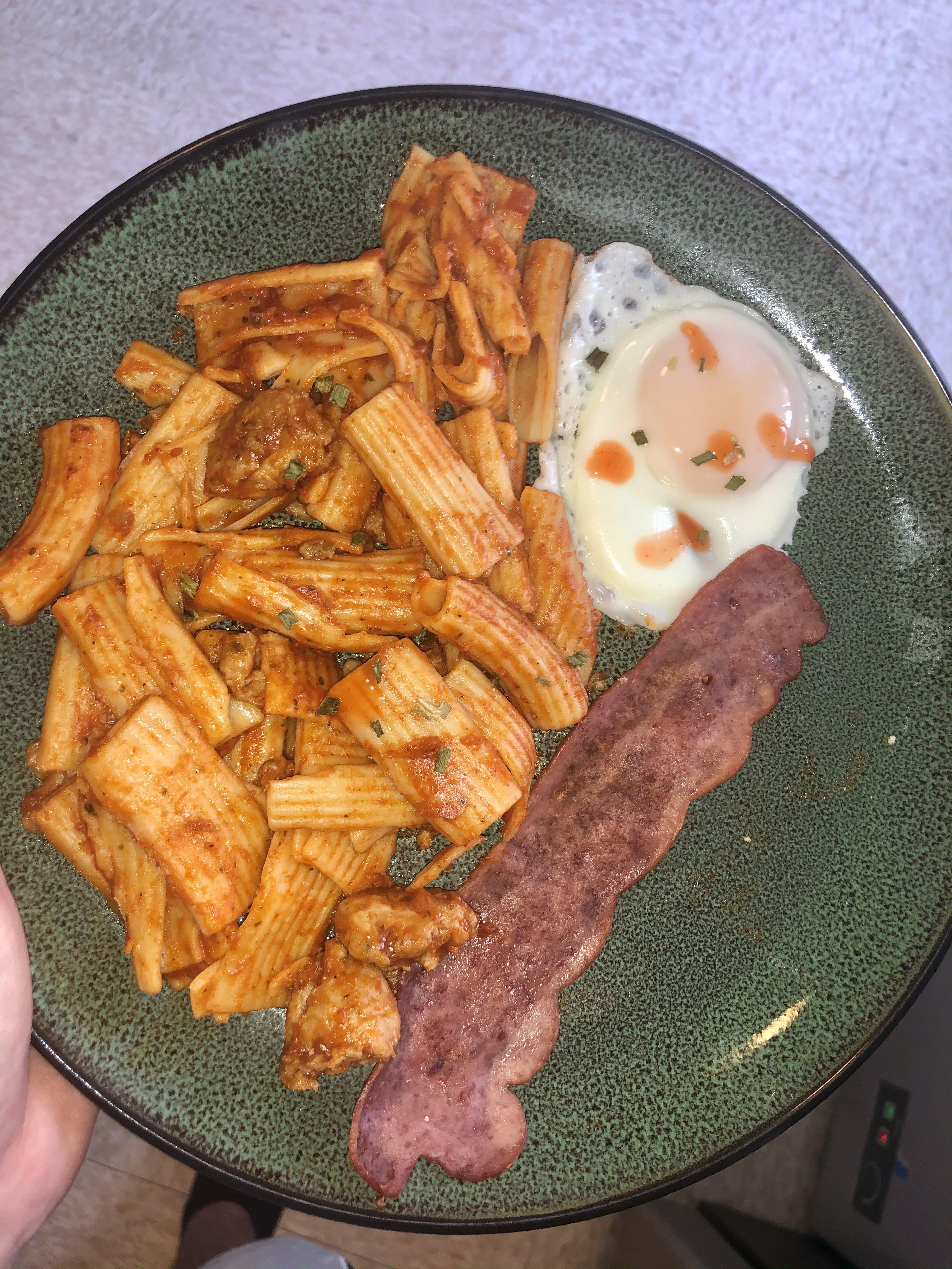 Leftover pasta, fried egg, turkey bacon one single slice, and dollar