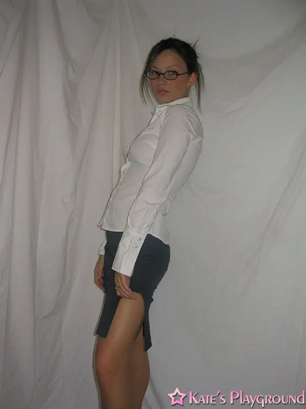 Kate in a sexy teacher outfit featuring a white blouse, tight grey pencil skirt, and glasses