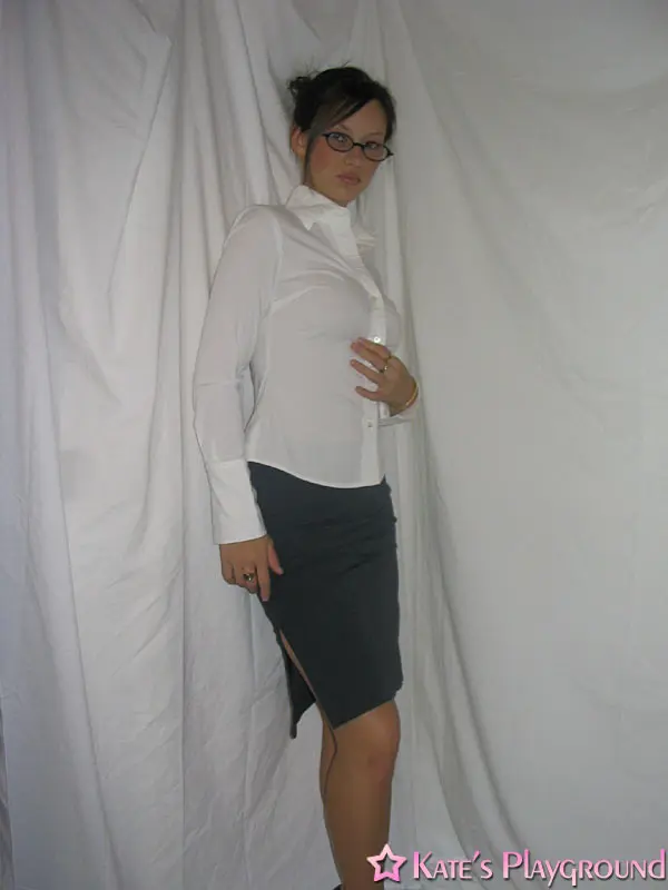 Kate in a sexy teacher outfit featuring a white blouse, tight grey pencil skirt, and glasses
