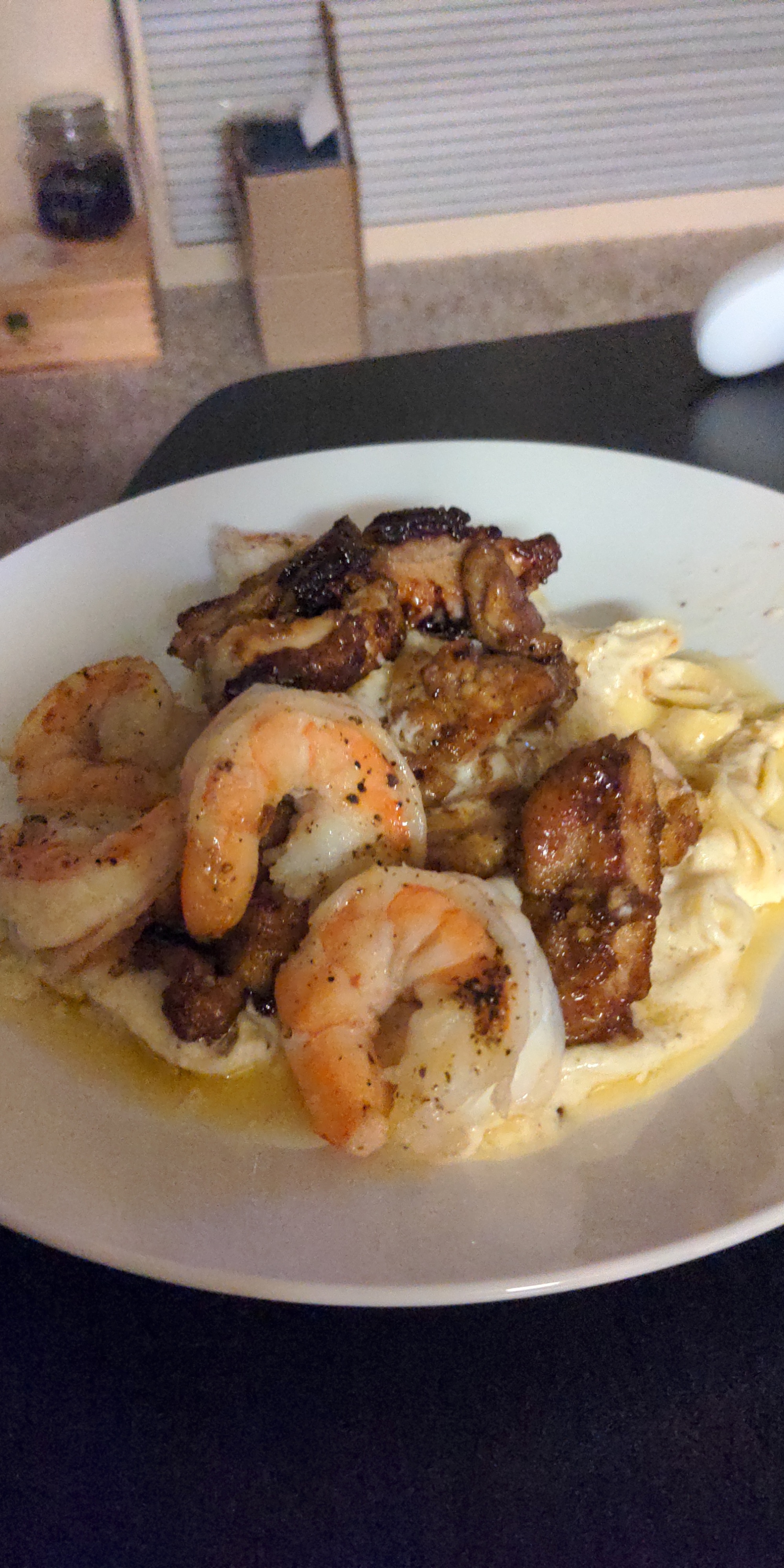 Shrimp and honey rum glazed chicken with homemade noodles and alfredo