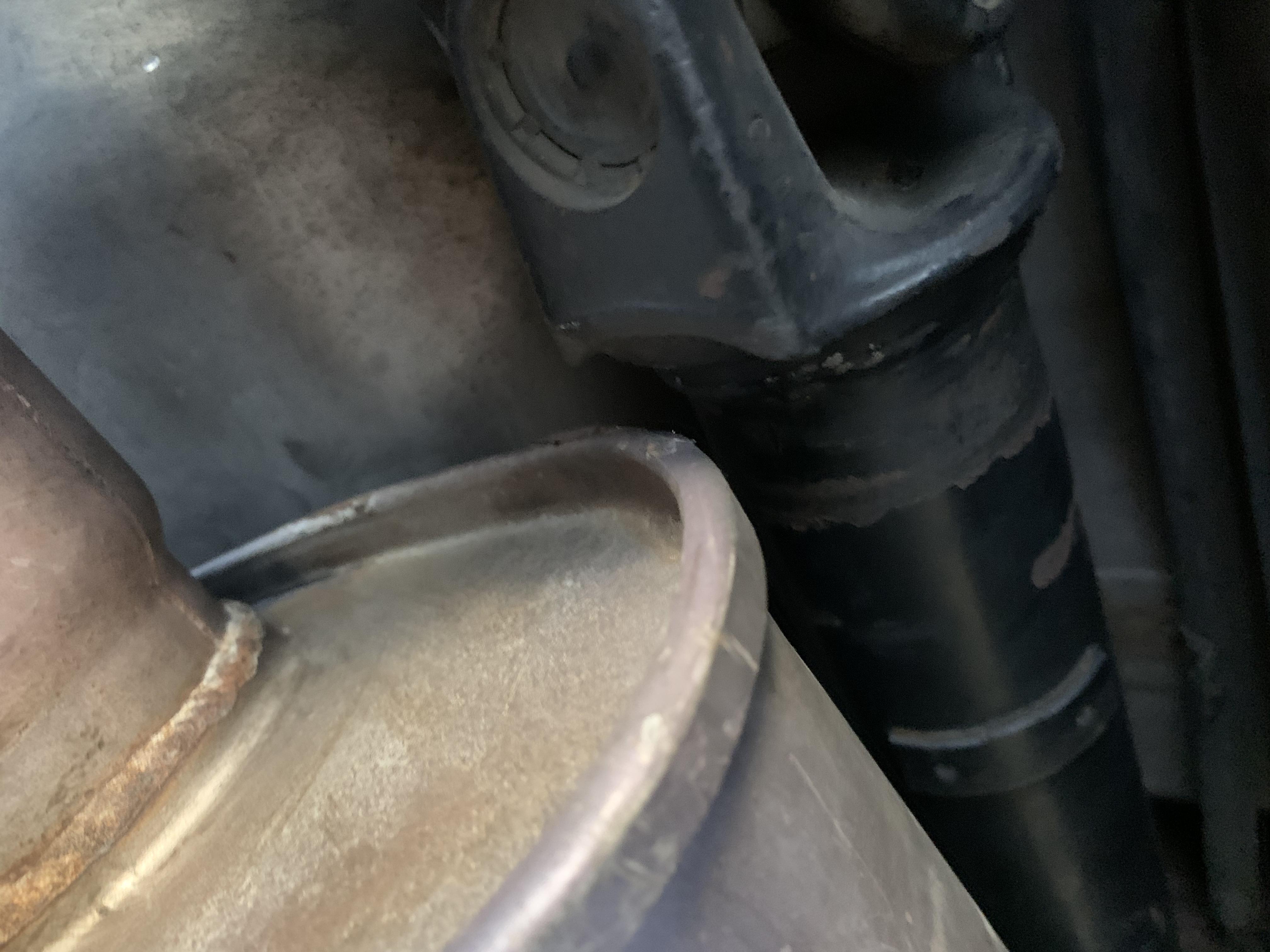 Tight squeeze. Drive shaft touching muffler causing serious rattle at