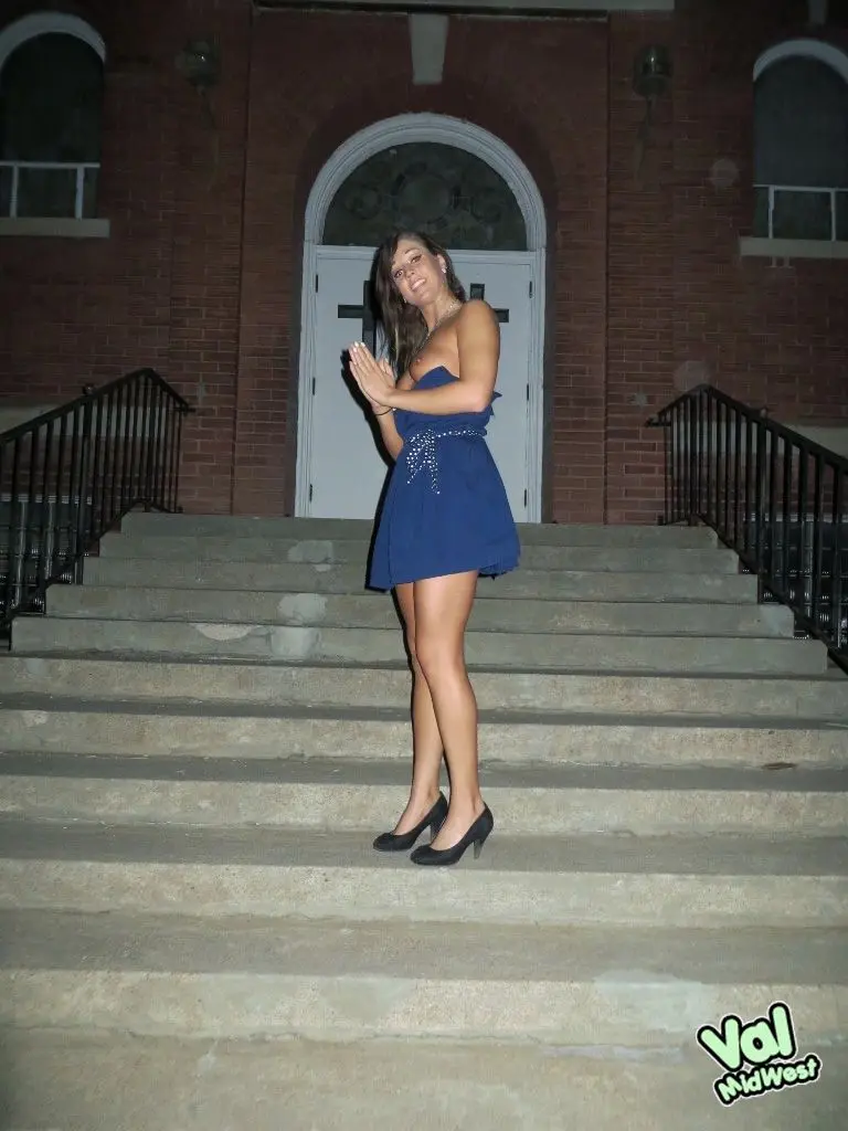 Val theWoo in a blue mini dress posing topless and lying in a garden planter at night