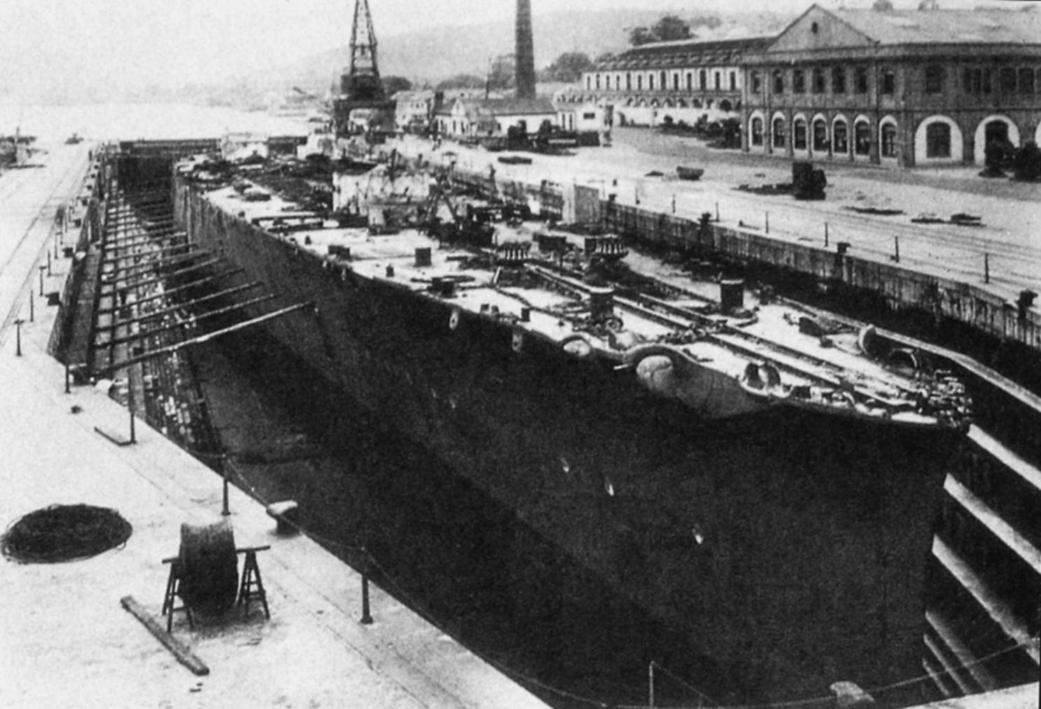 [1489x1014] The hull of the former Italian heavy cruiser Trieste, sunk in April 1943, raised postwar, and bought by the Spanish Navy with the intention of converting her into a light carrier, in drydock at the El Ferrol shipyard, 1951