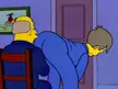 The Simpsons cartoon of a man in a blue suit bending over while another man in a blue suit watches from a chair.