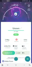 Shiny Unown Pokémon in a Pokémon GO profile interface, a rare blue animal with a single eye.
