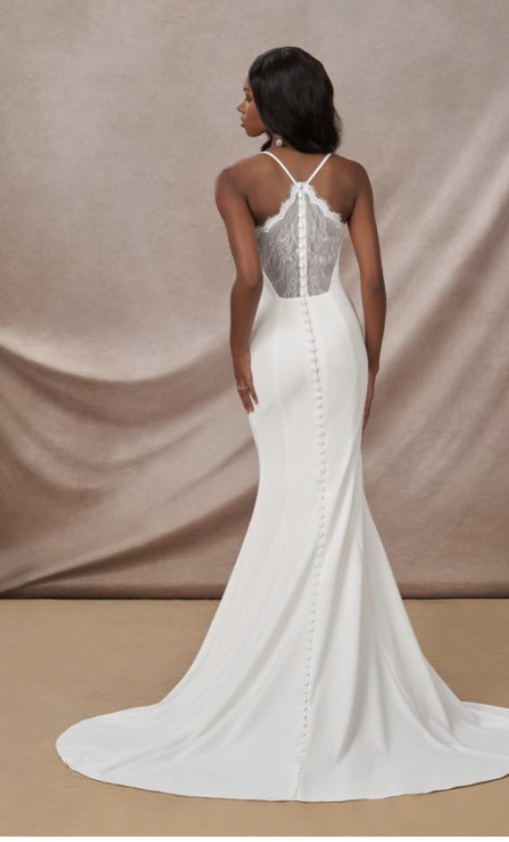 Asian woman with brown hair bun and pearl earrings, and a Black woman in an Azazie Calypso white wedding dress