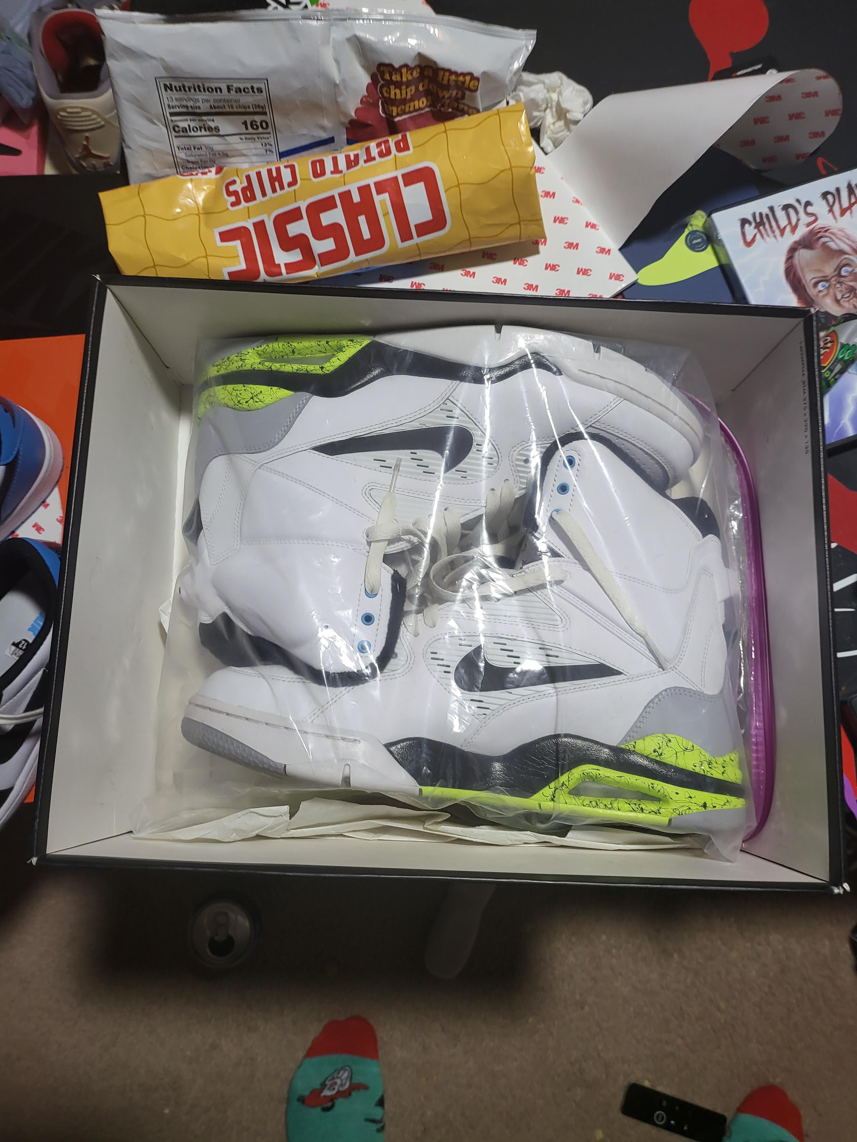 Command Force black and white high-top sneakers sitting on a black shoe box