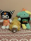 BiFloof, Kuromi, and ZomZomPurin Build-A-Bear plush toys sitting on a patterned brown and white surface.