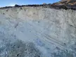 found this layered wall of something i do not know. it's soft and qhen rubbed it turns powdery