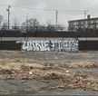 Graffiti art featuring the word UNKIE on a concrete wall in a desolate urban lot in St. Louis, Missouri