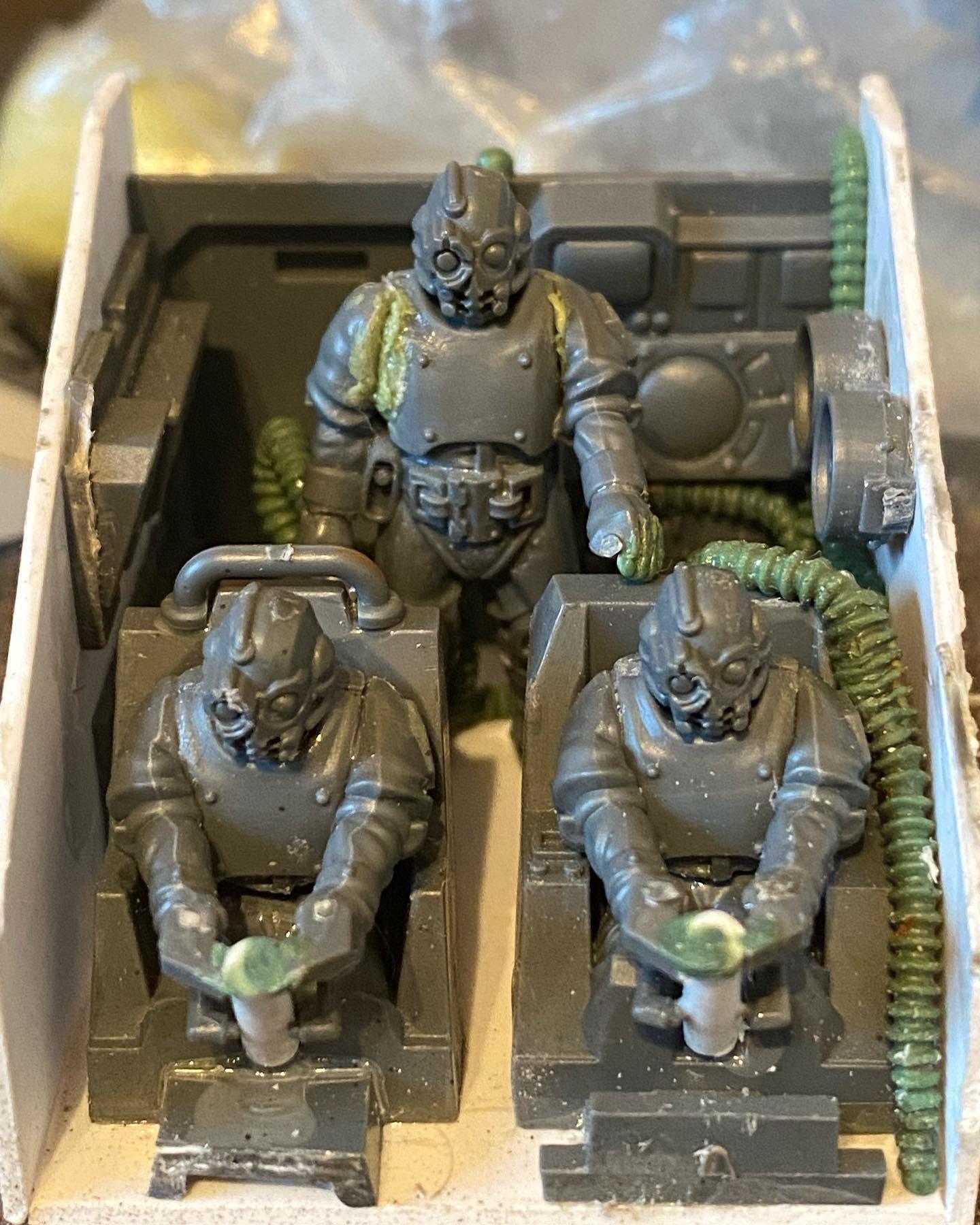 Custom-built Tyrannofex miniature vehicle model and crew on a green cutting mat