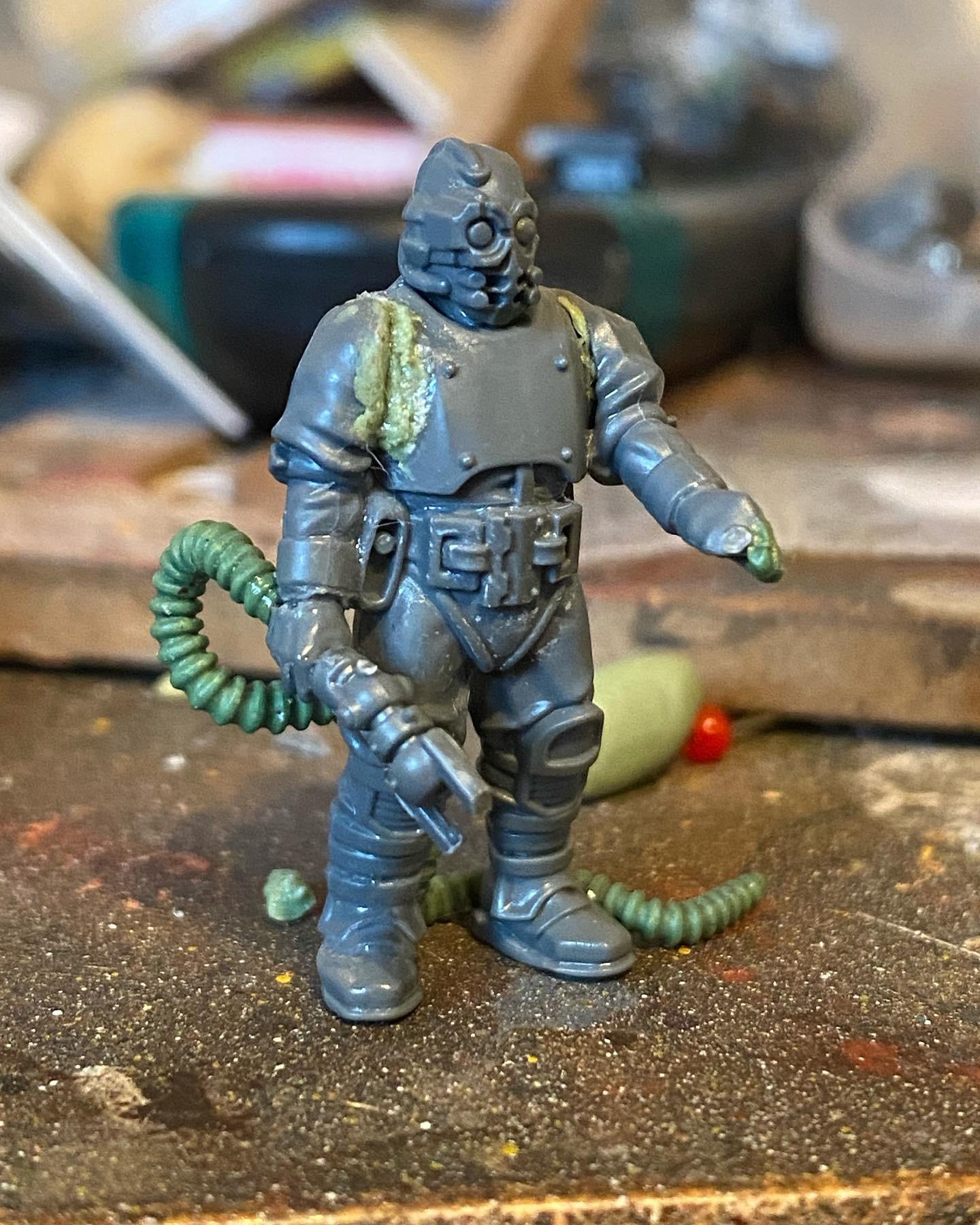 Custom-built Tyrannofex miniature vehicle model and crew on a green cutting mat