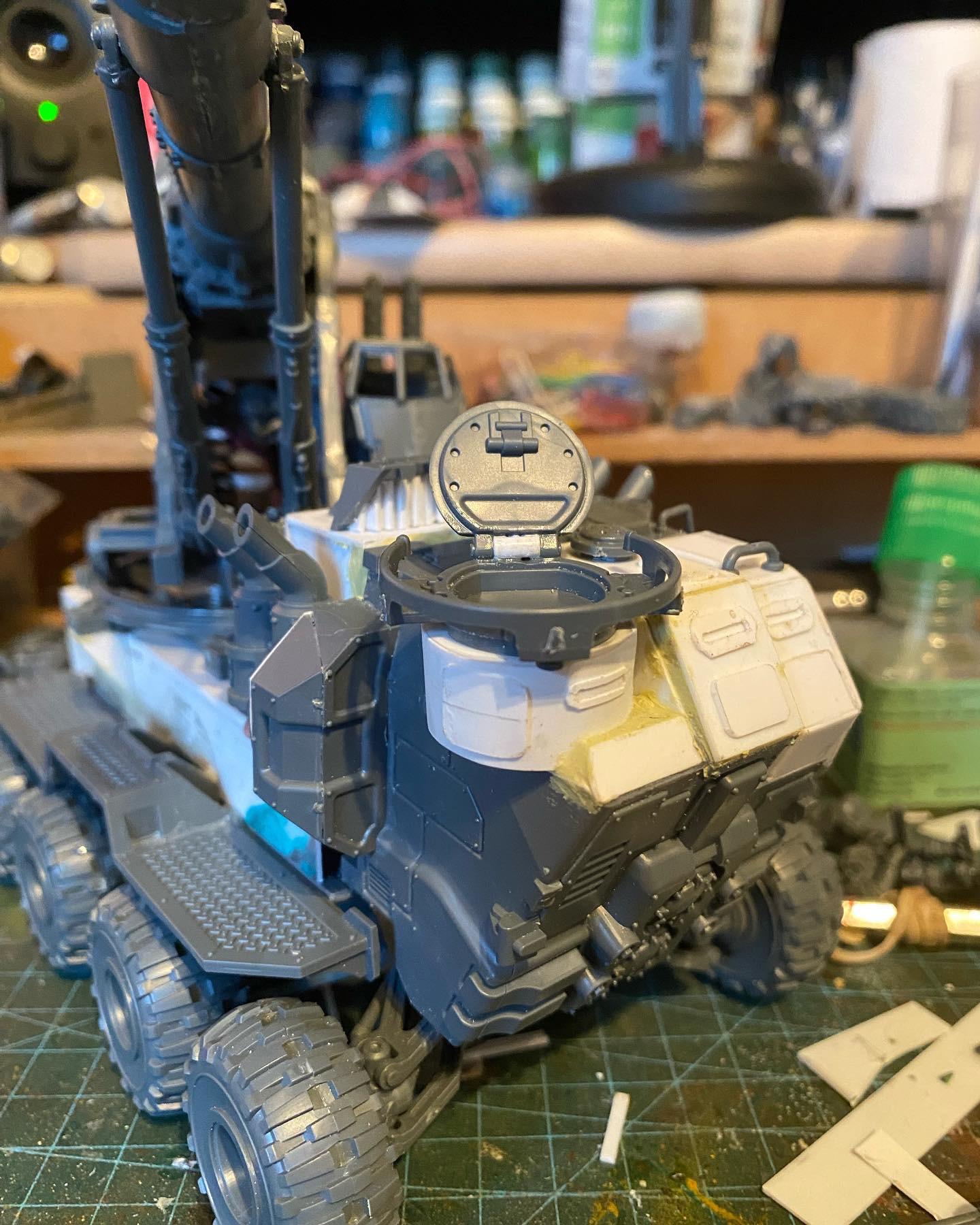 Custom-built Tyrannofex miniature vehicle model and crew on a green cutting mat