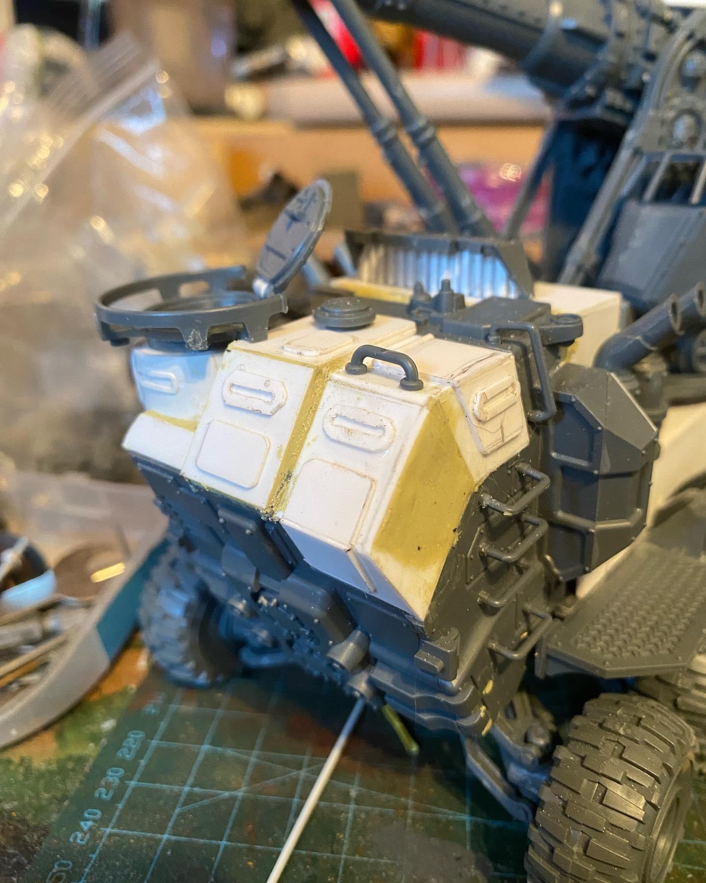 Custom-built Tyrannofex miniature vehicle model and crew on a green cutting mat