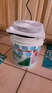 Swamp cooler from a drywall bucket, aquarium tubing and pump, fan, and dura cool material.