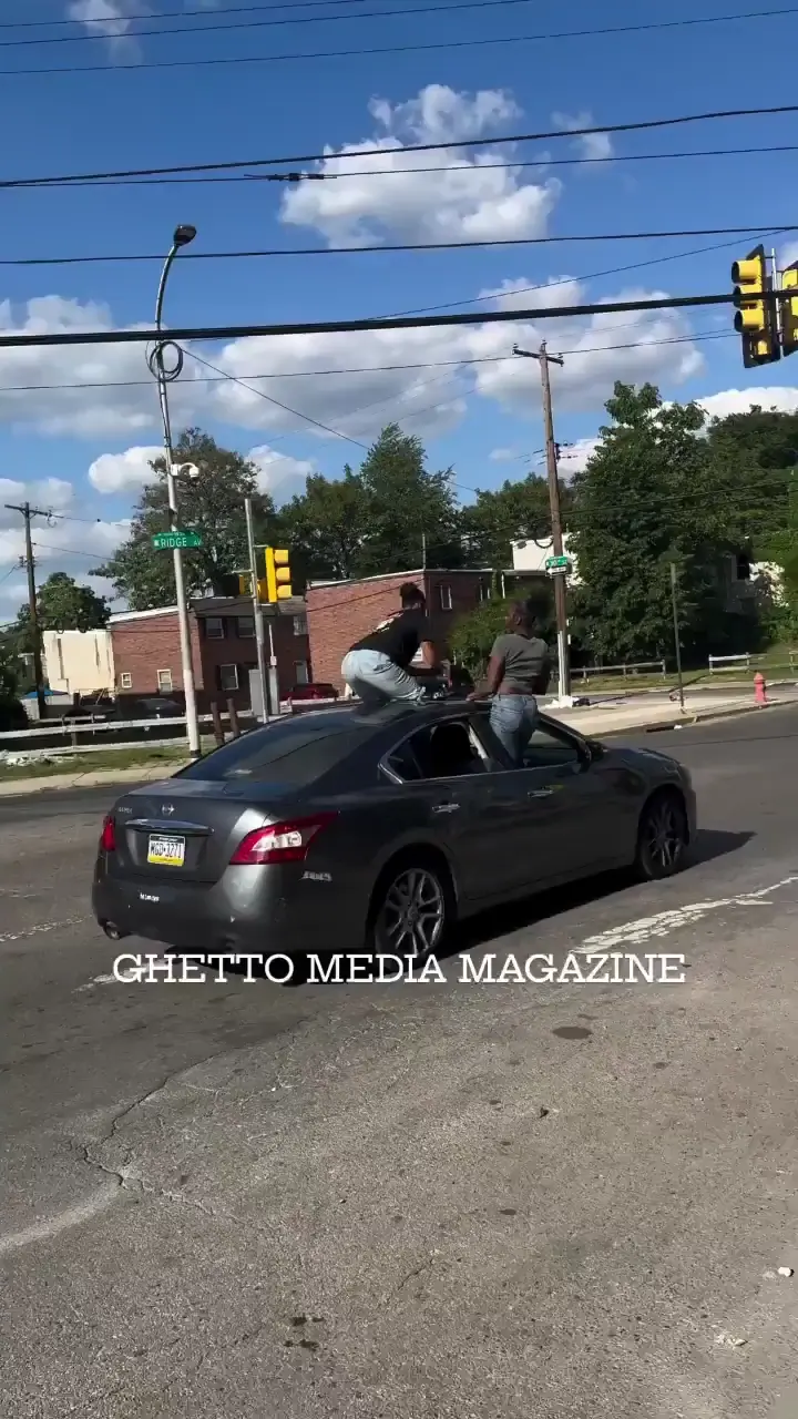 2 girls twerking on top of the car while the car is driving