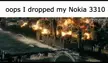 Dank meme of a ruined city with smoke and fire, captioned 'oops I dropped my Nokia 3310'