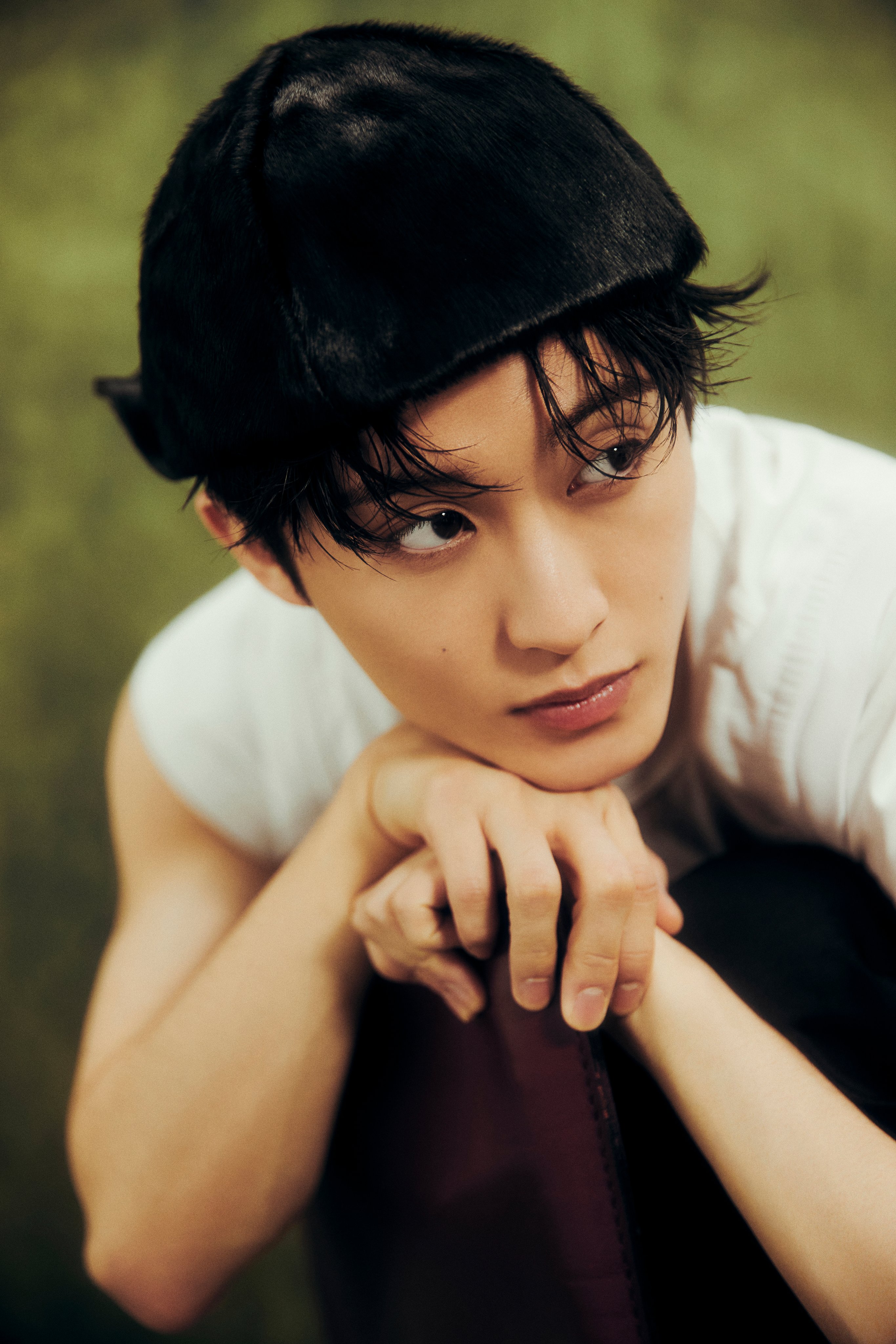 NCT Mark in a white t-shirt, black trousers, and black cap for The Firstfruit teaser