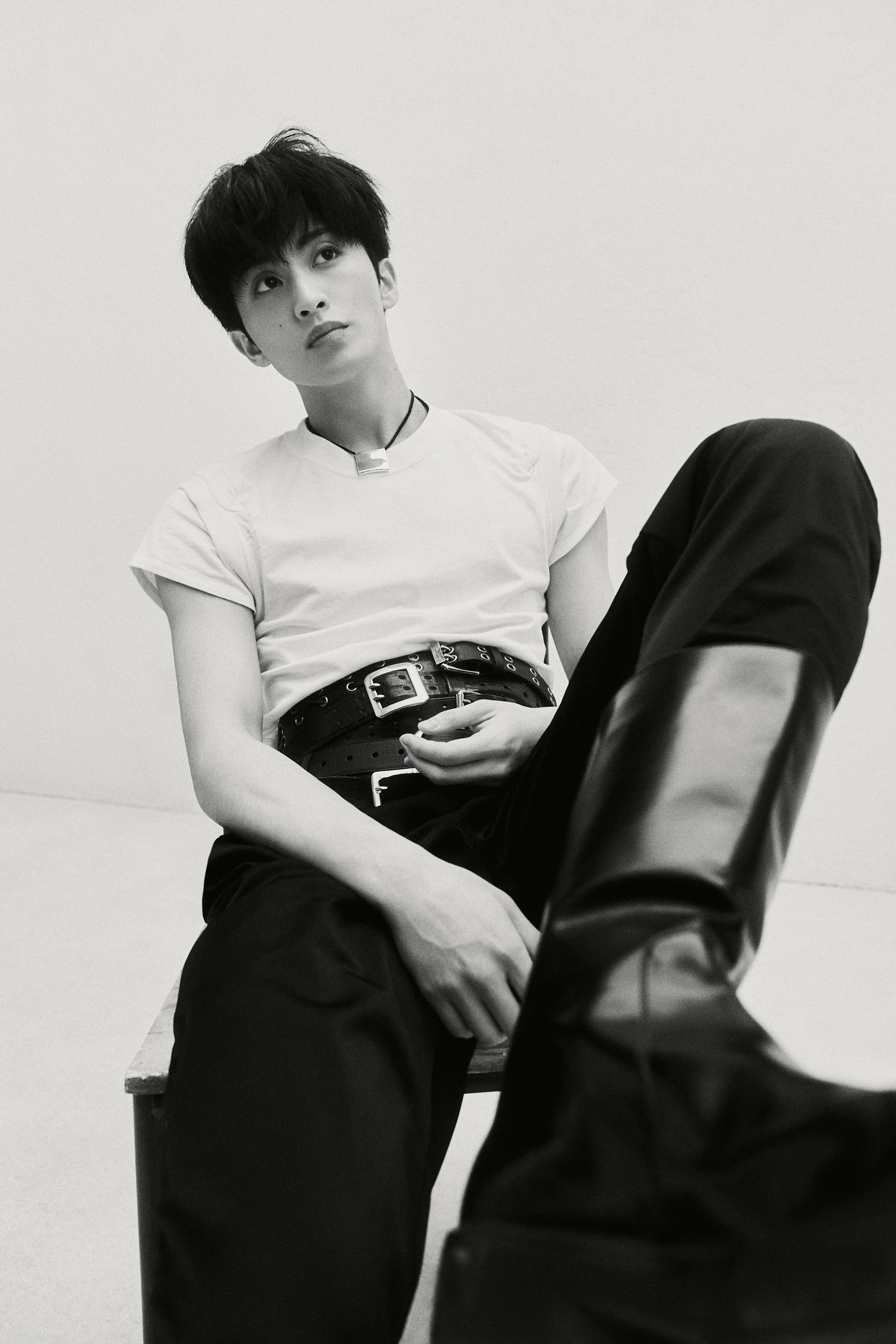 NCT Mark in a white t-shirt, black trousers, and black cap for The Firstfruit teaser