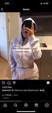 Curvy woman in a white hoodie and sweatpants revealing a blue bikini halter top in a mirror selfie.
