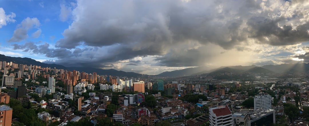 Medellin, Colombia city skyline and mountains under a dramatic cloudy sky