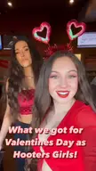 Annabelle and another Hooters girl in red and pink outfits showing off Valentine's Day gifts like chocolate and pizza.
