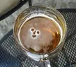 The foam in the beer glass looks like a smiley face