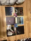 Kanye West's The Life of Pablo vinyl and CDs on a wooden floor with streetwear sneakers