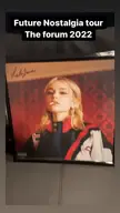 Dua Lipa signed vinyl records from the Future Nostalgia tour at The Forum 2022, featuring close-up views of album covers.