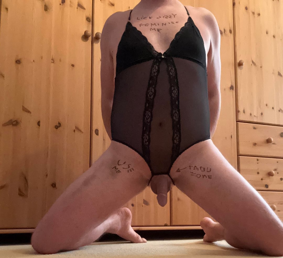 Sissy in black lace bodysuit with body writing kneeling on the floor