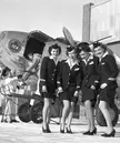 1949, Winnipeg, Canada: Trans-Canada Airlines flight attendants show off nylon stockings reintroduced to their uniforms following WWII.