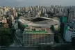 Aerial view of Palmeiras' stadium in downtown São Paulo, Brazil, surrounded by a dense city skyline.