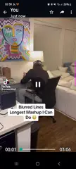 A slim blonde man in a black quarter-zip and white baseball cap dancing in his living room for a TikTok challenge.