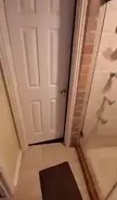 A person in white shorts touring a home with a shoe closet, indoor obstacle course, ball pit, and climbing wall.