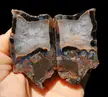 Quartz framed by agate that changes from black to brown and a wonderful tiny sticks and moss formation at the bottom.