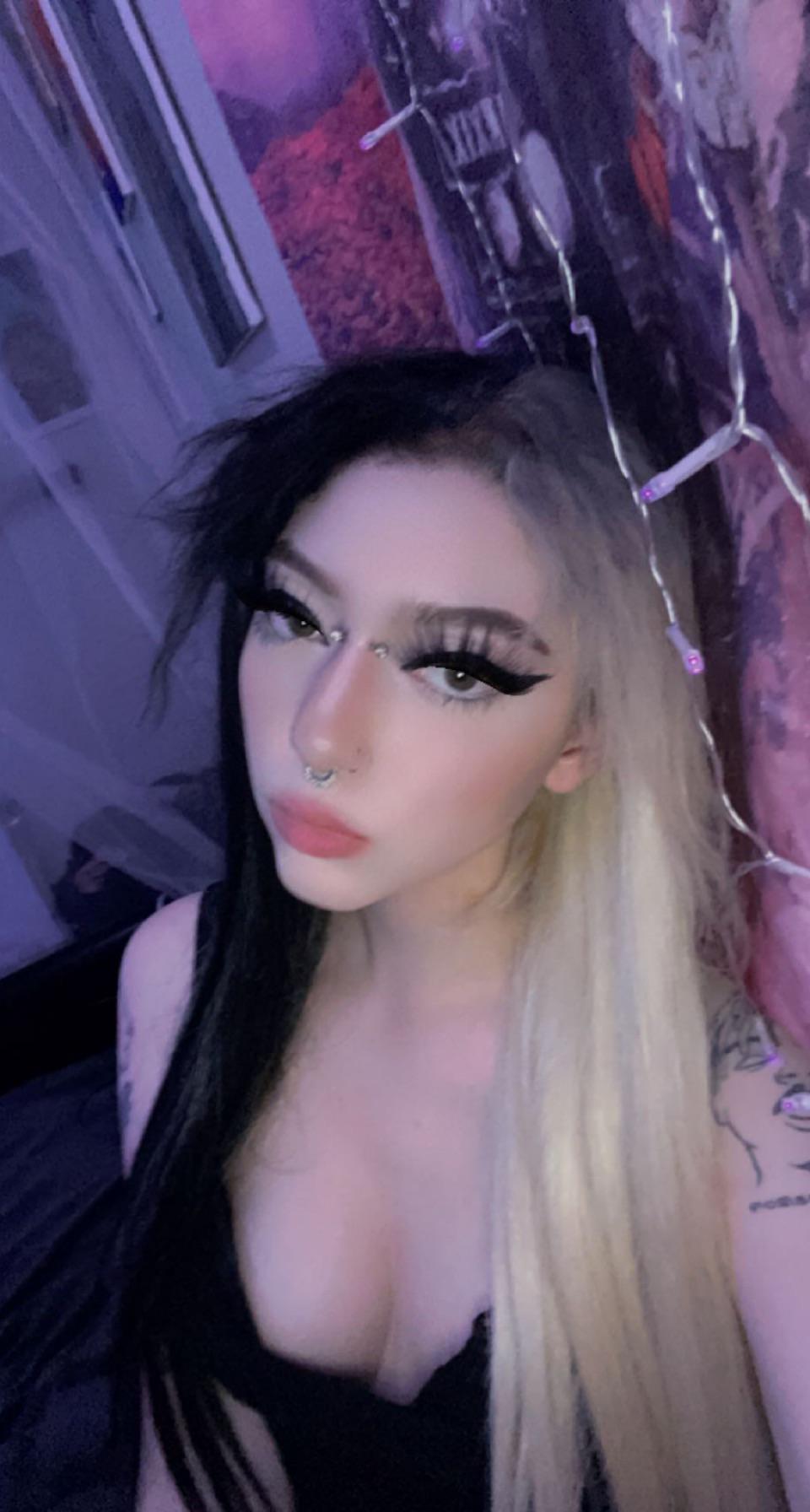 E-girl with split-dyed black and blonde hair and a black top