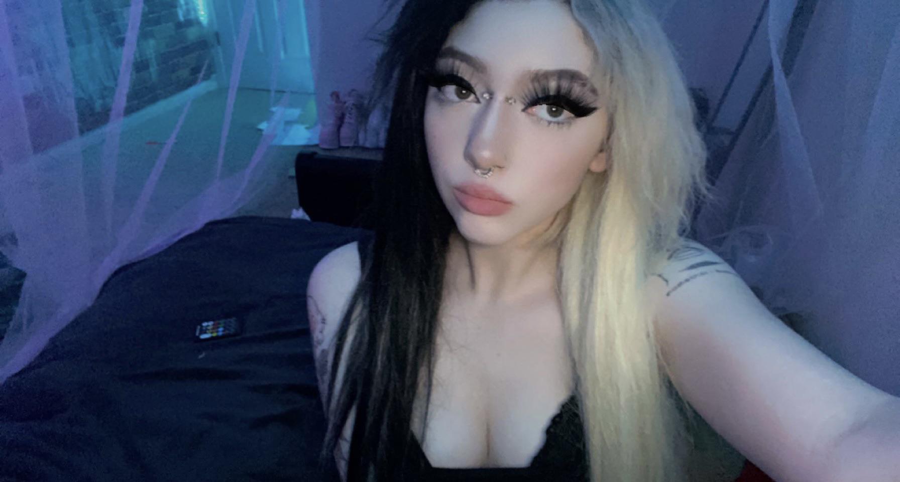E-girl with split-dyed black and blonde hair and a black top