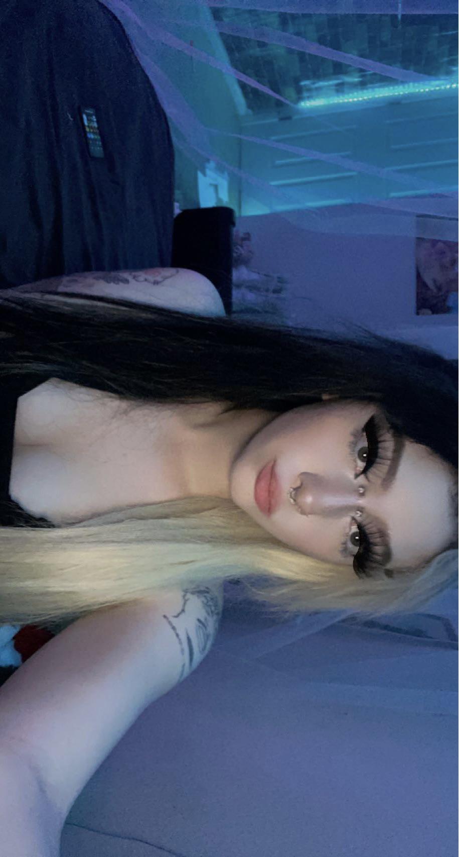 E-girl with split-dyed black and blonde hair and a black top