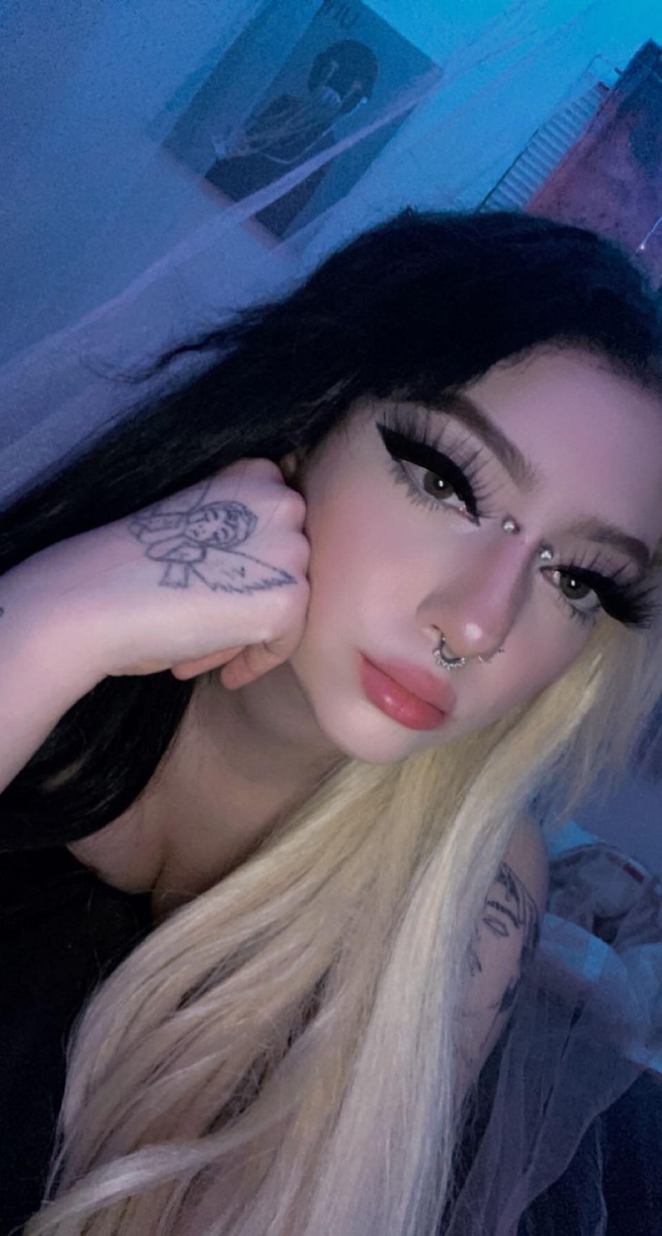 E-girl with split-dyed black and blonde hair and a black top