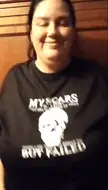 Busty BBW woman in a black t-shirt performing a titty drop, exposing her large breasts and belly with scars.
