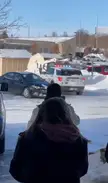 A man steals a skid loader and hits a police vehicle in a snowy Home Depot parking lot.