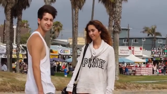 A fan approaches Chris on the beach and asks for a kiss.