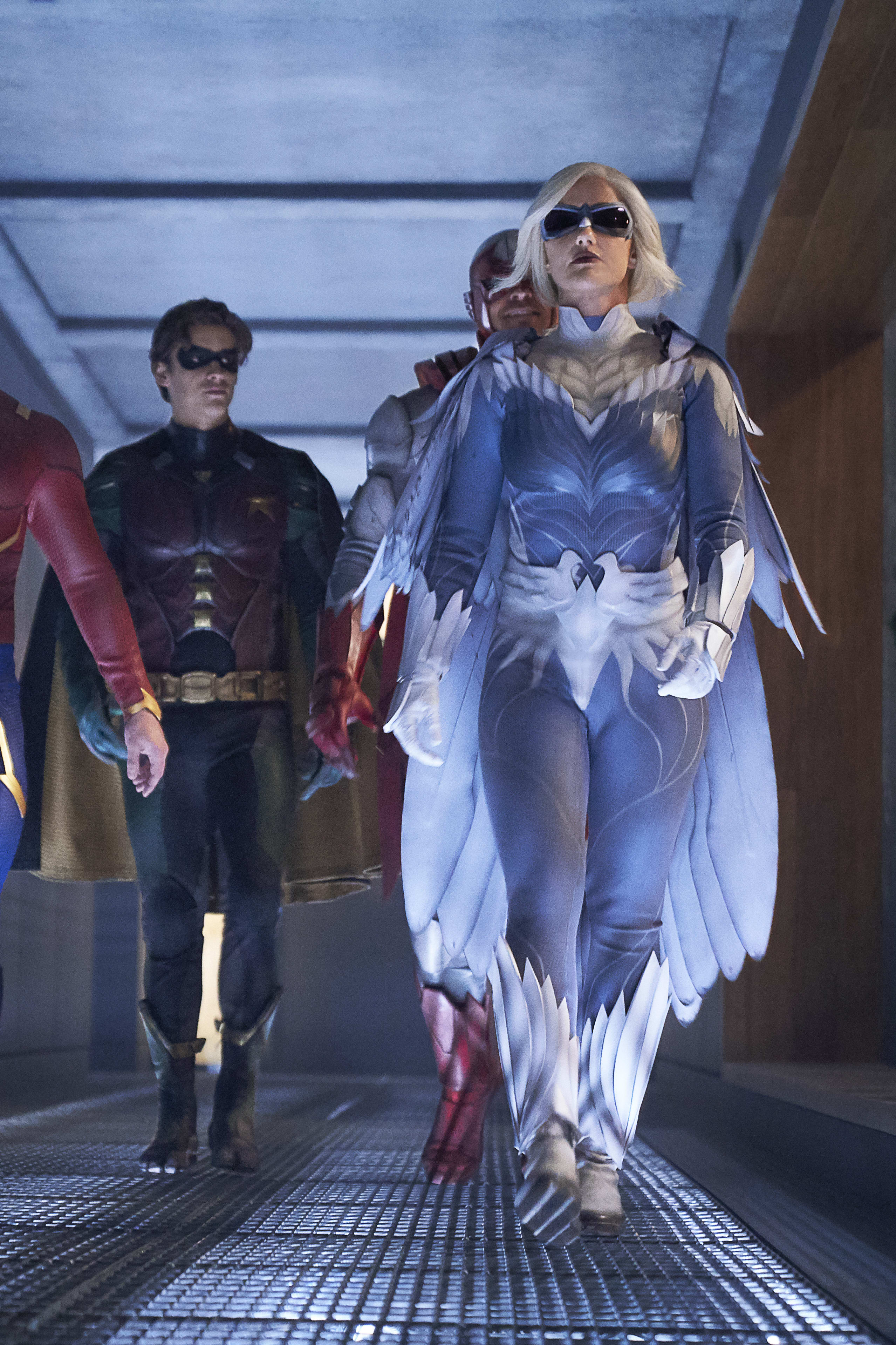 Female DC Comics characters in superhero and villain costumes, including a red bodysuit and a clown outfit.