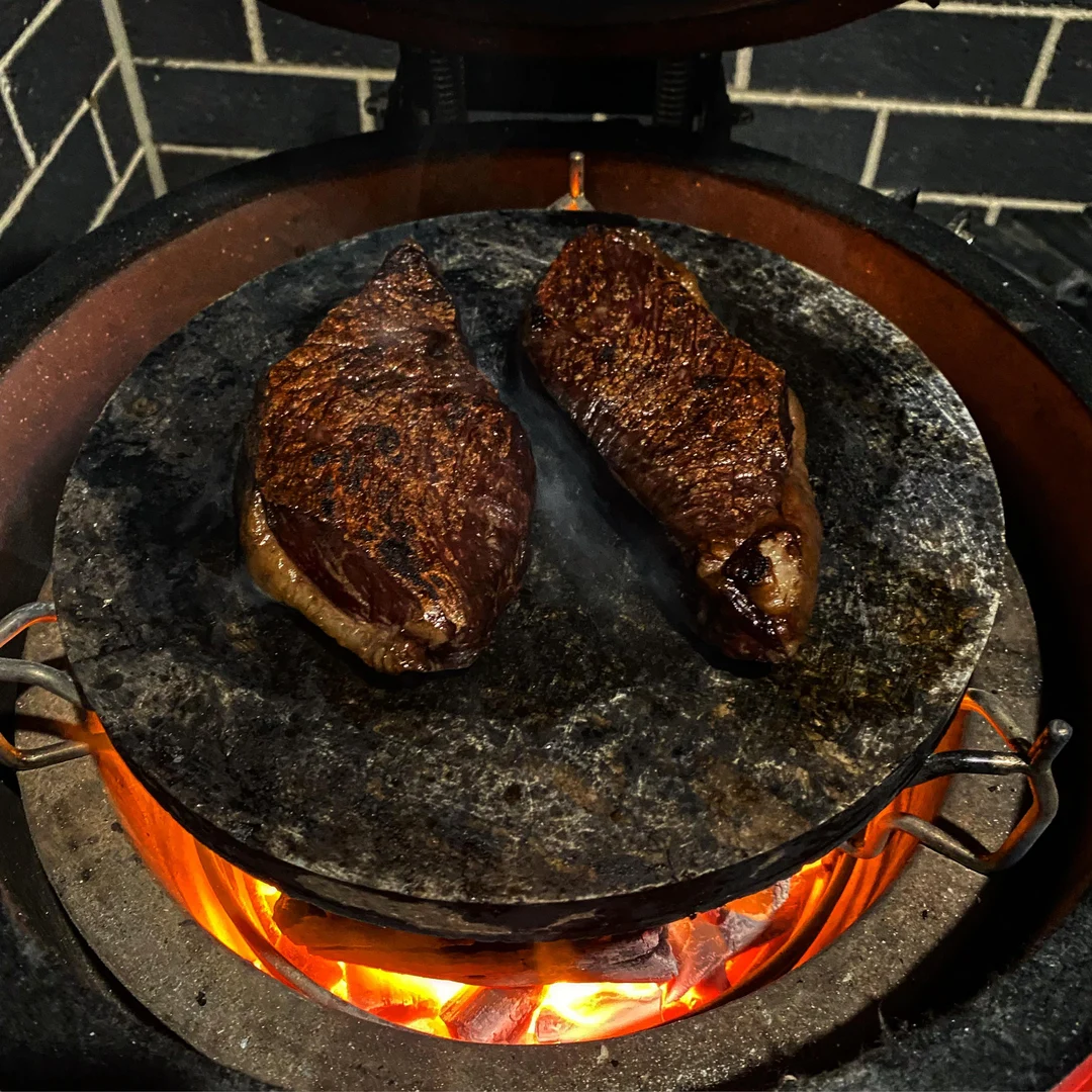 Meat cooked on a really hot rock | Scrolller